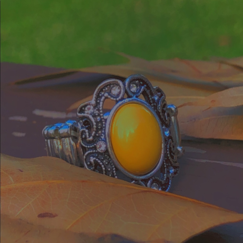 stretchable large ring with yellow crystal.